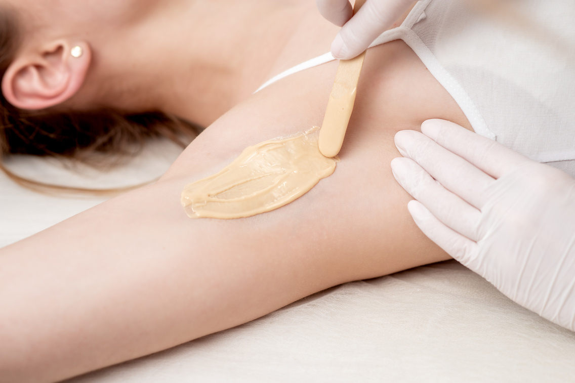 Cosmetologist Applying Wax on a Woman’s Armpit Closeup
