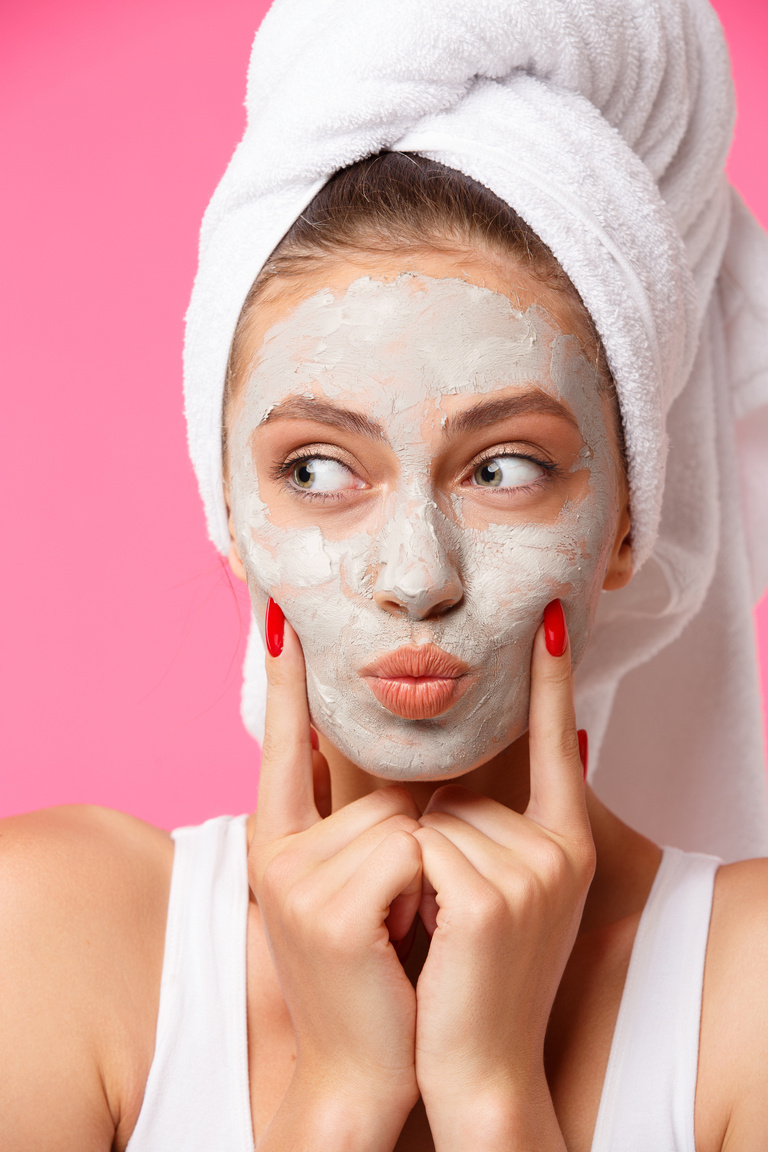 Beauty Treatment - Woman Applying Clay Face Mask
